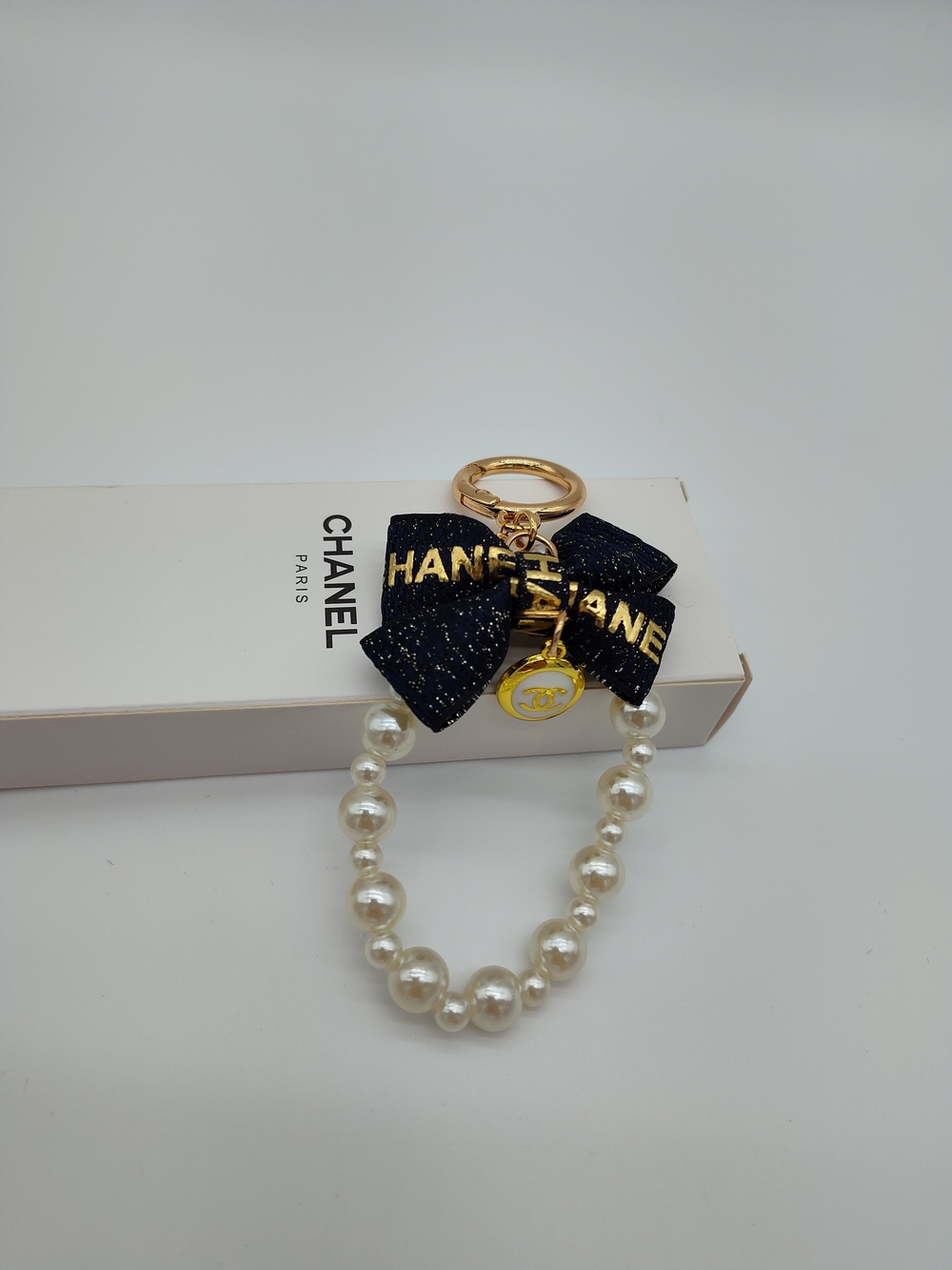 CHANEL Pearl Deep Navy Ribbon CC Charm Keychain Bag Charm Gold Tone NIB